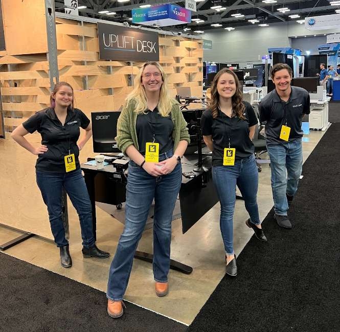 UPLIFT Desk employees at SXSW booth