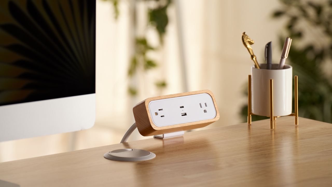 White DuoMount Strip clamped onto Uplift Standing Desk.