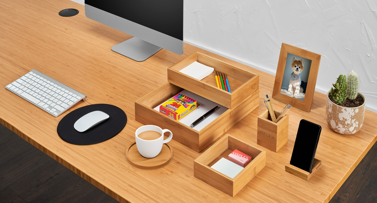 Bamboo Desk by UPLIFT Desk featuring the Bamboo Organizer Set with stored office supplies.