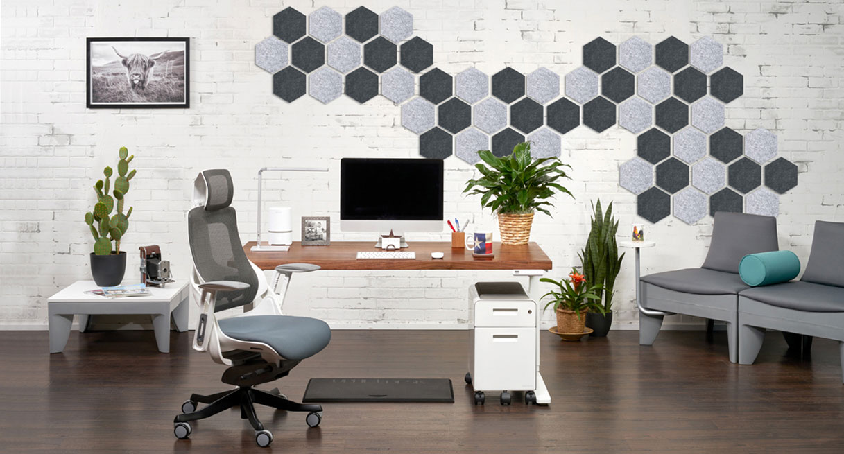 A home office with Hive Acoustic Wall Tiles in light and dark gray covering one wall