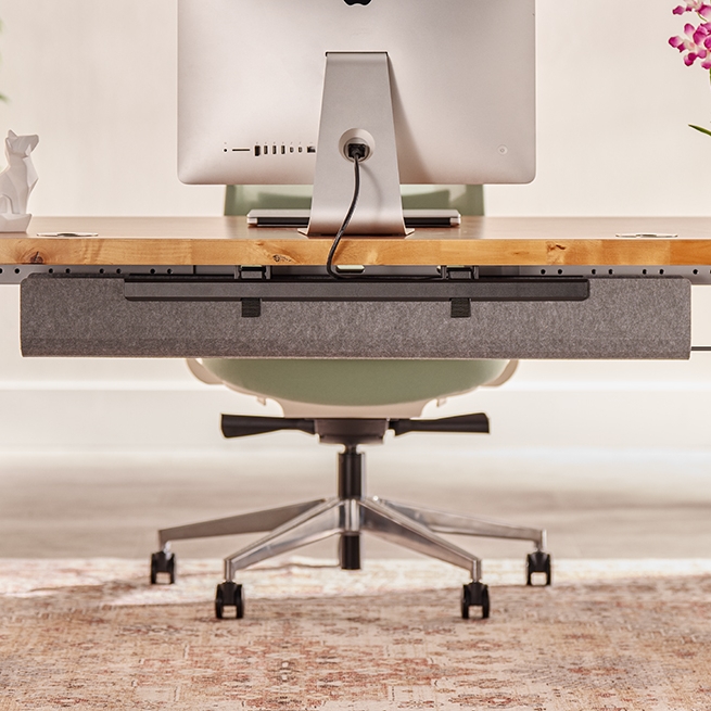 Flexmount cable tray attached to an UPLIFT standing desk to keep cords tidy.