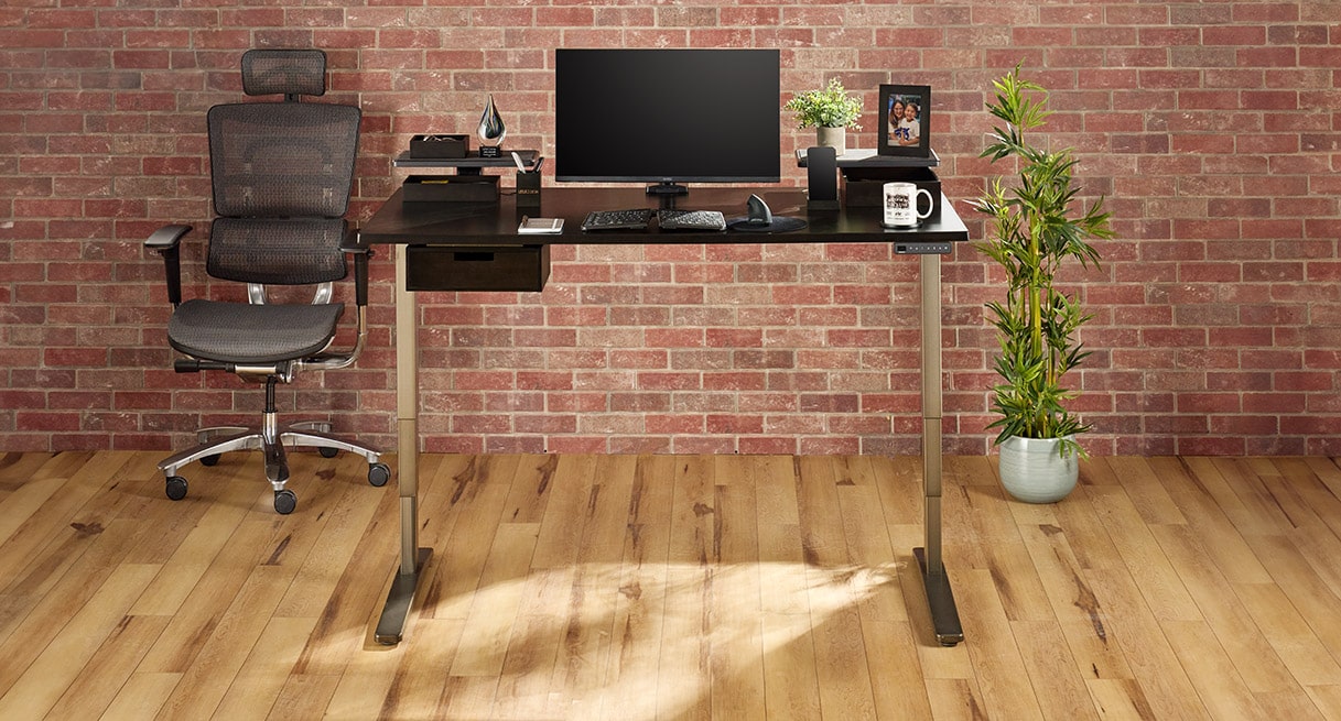 UPLIFT Standing Desk with various desk accessories including the Bamboo Desk Organizer Set.