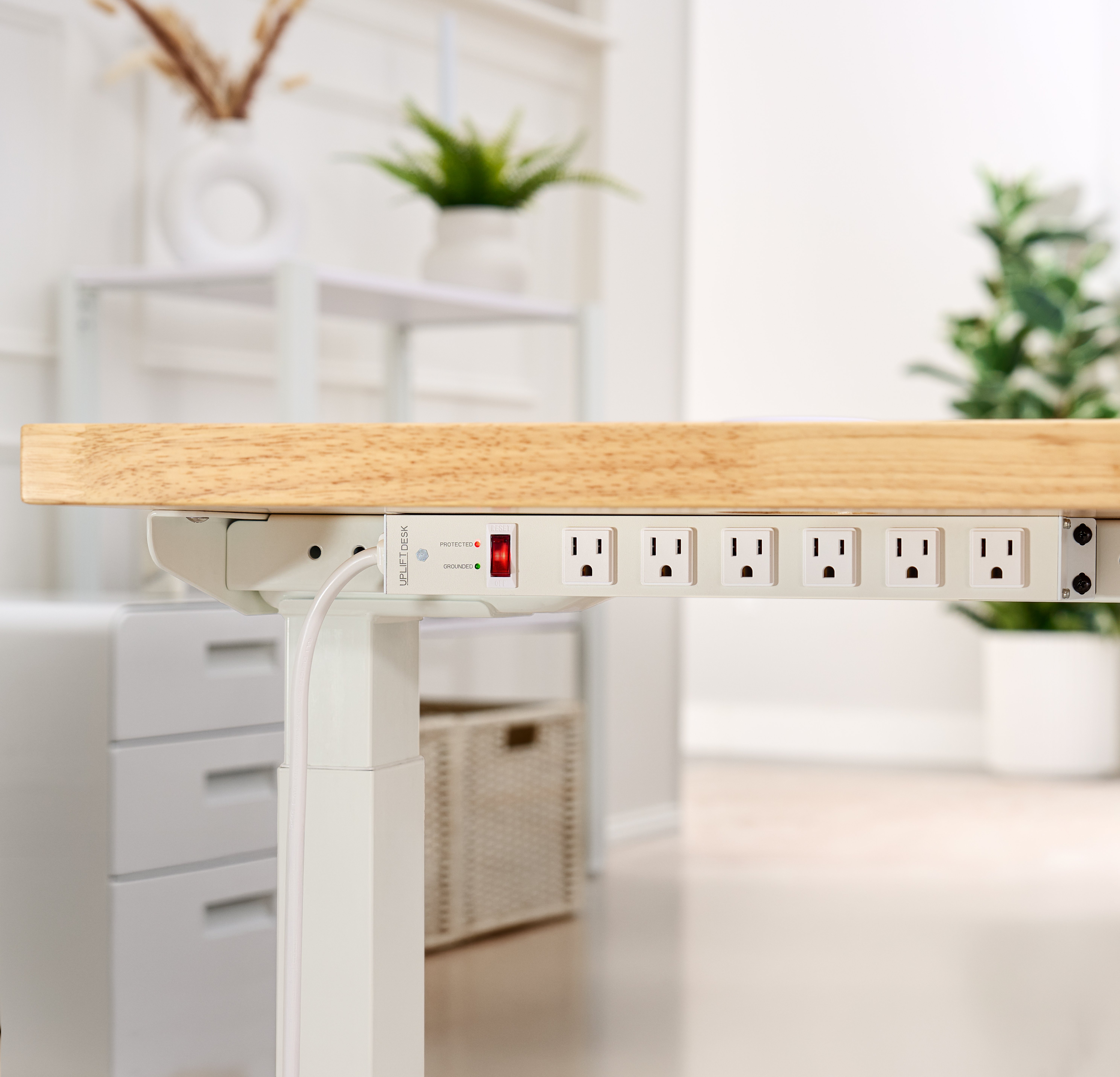 Mountable Surge Protector featured in white by UPLIFT Desk