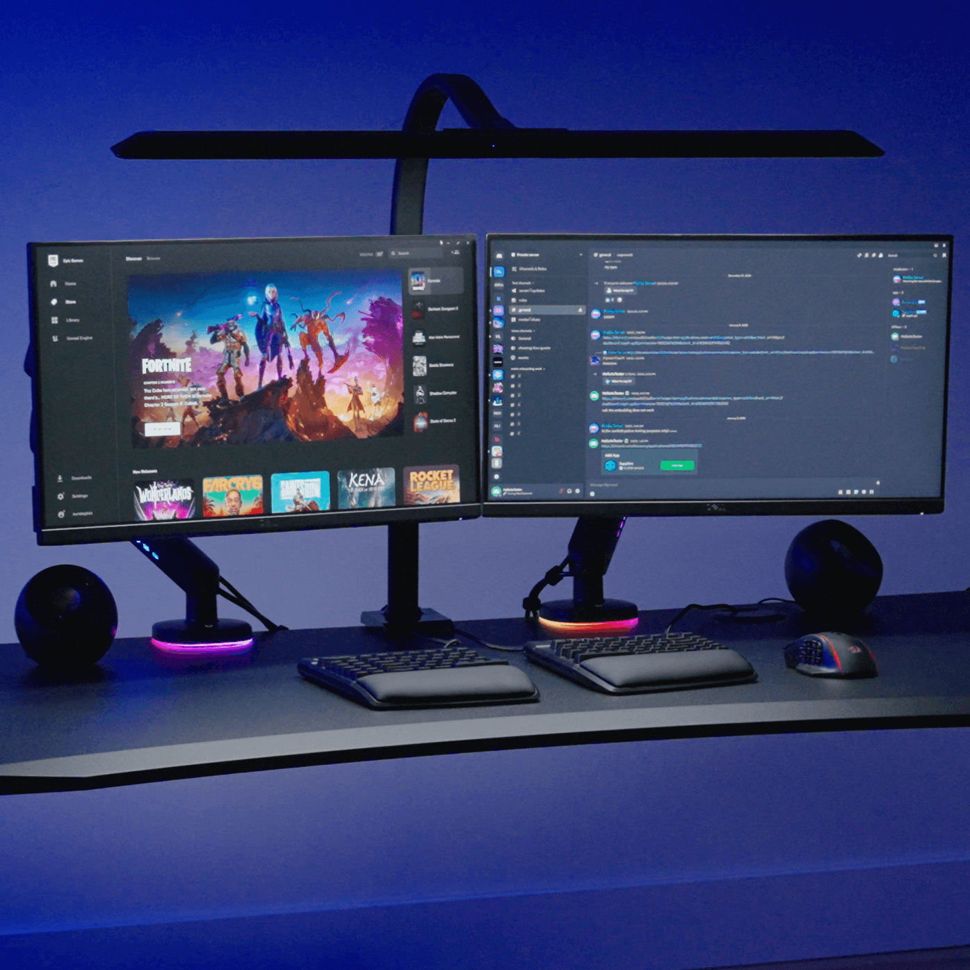 UPLIFT Desk Sliding Flex Lamp illuminating an all-black gaming standing desk setup.