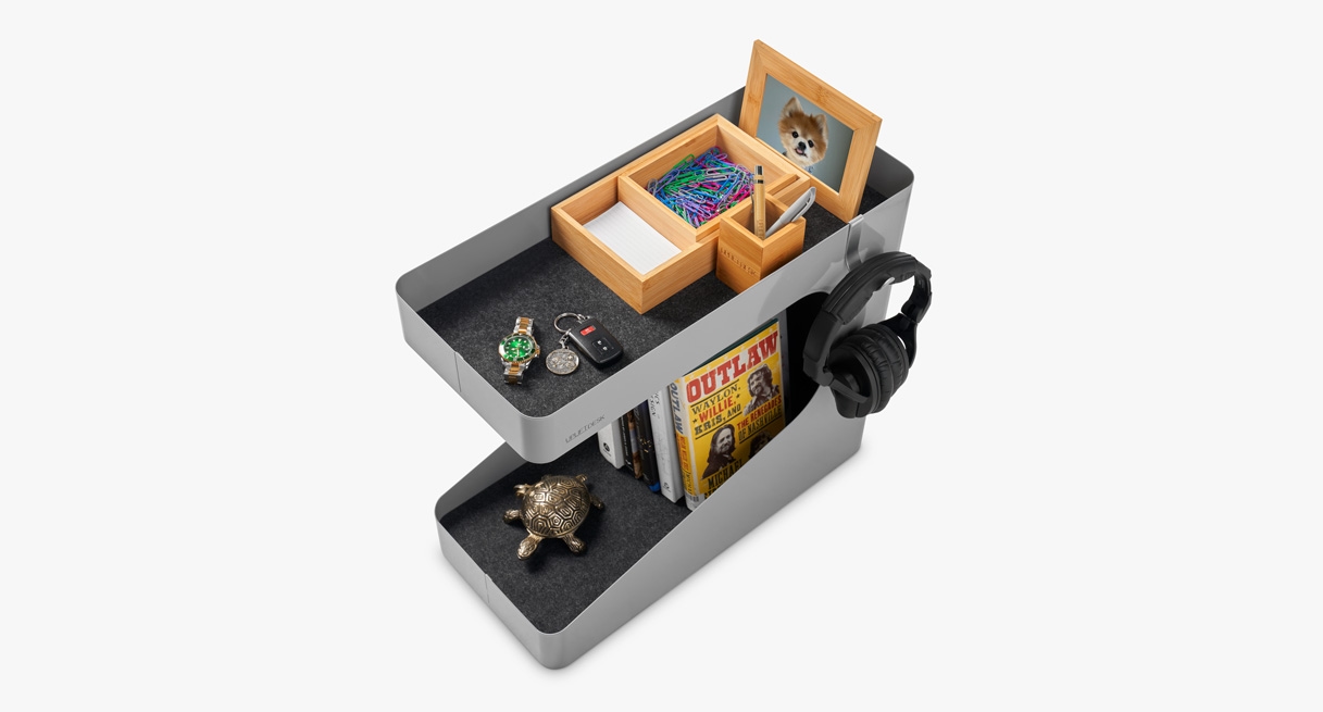 A storage caddy with parts of the bamboo desk organizer on top