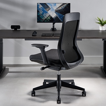 Bolan ergonomic chair in black at a black uplift standing desk.