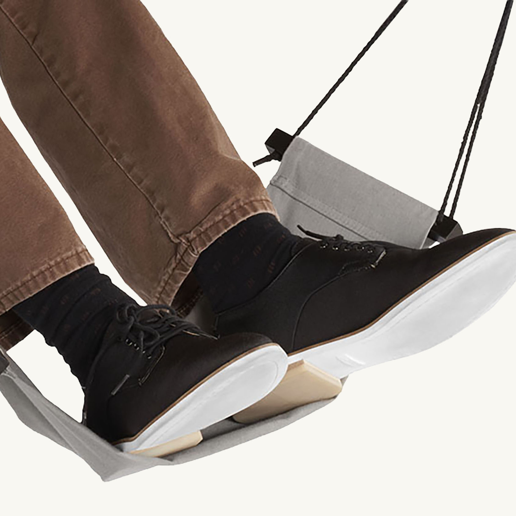 Person resting their feet on the under desk Foot Hammock.