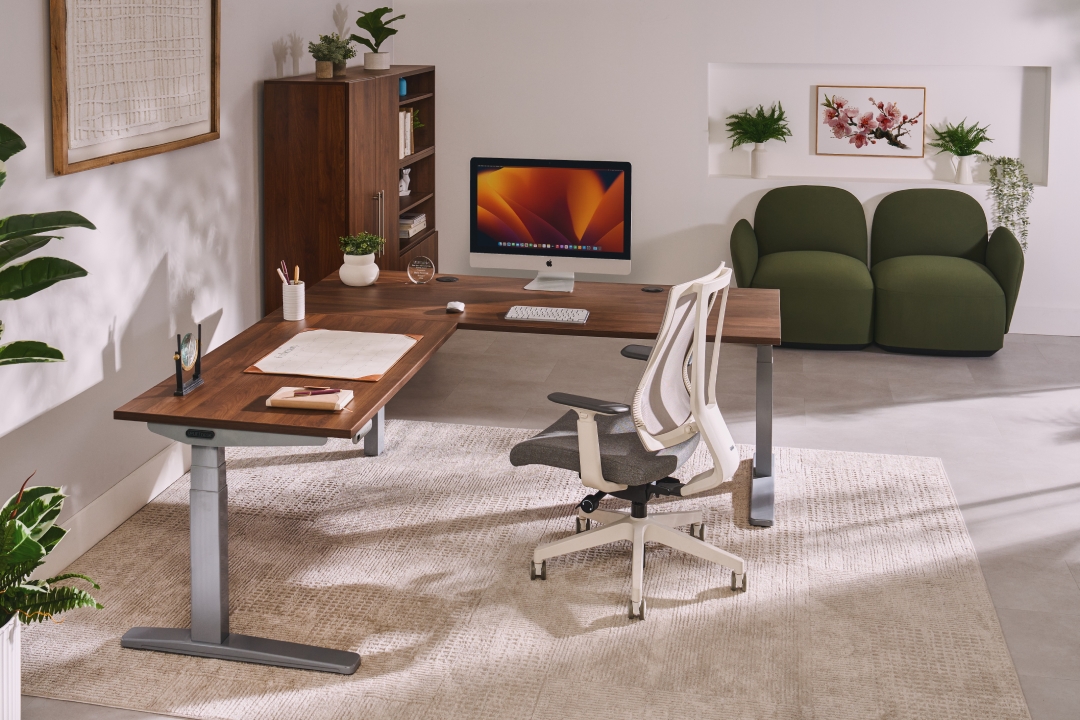 UPLIFT l-shaped standing desk with a Clarkville Ergonomic chair in a private executive office.