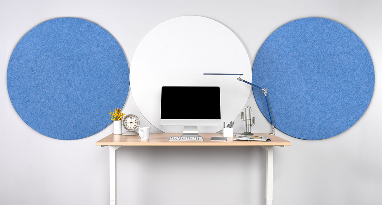 Circular Acoustic Wall Panels in blue and white behind a standing desk