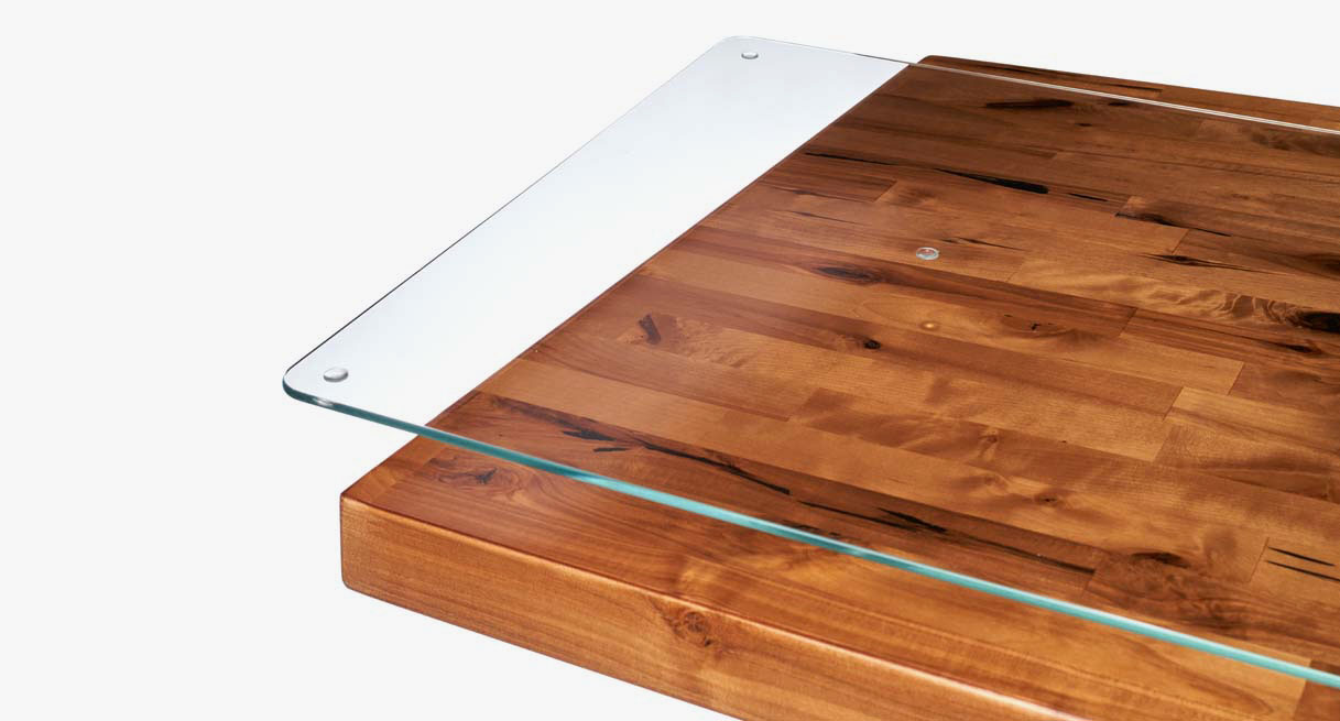 The strong, safe, durable tempered glass used in the UPLIFT Glass Desk Blotter seen over a solid wood desktop