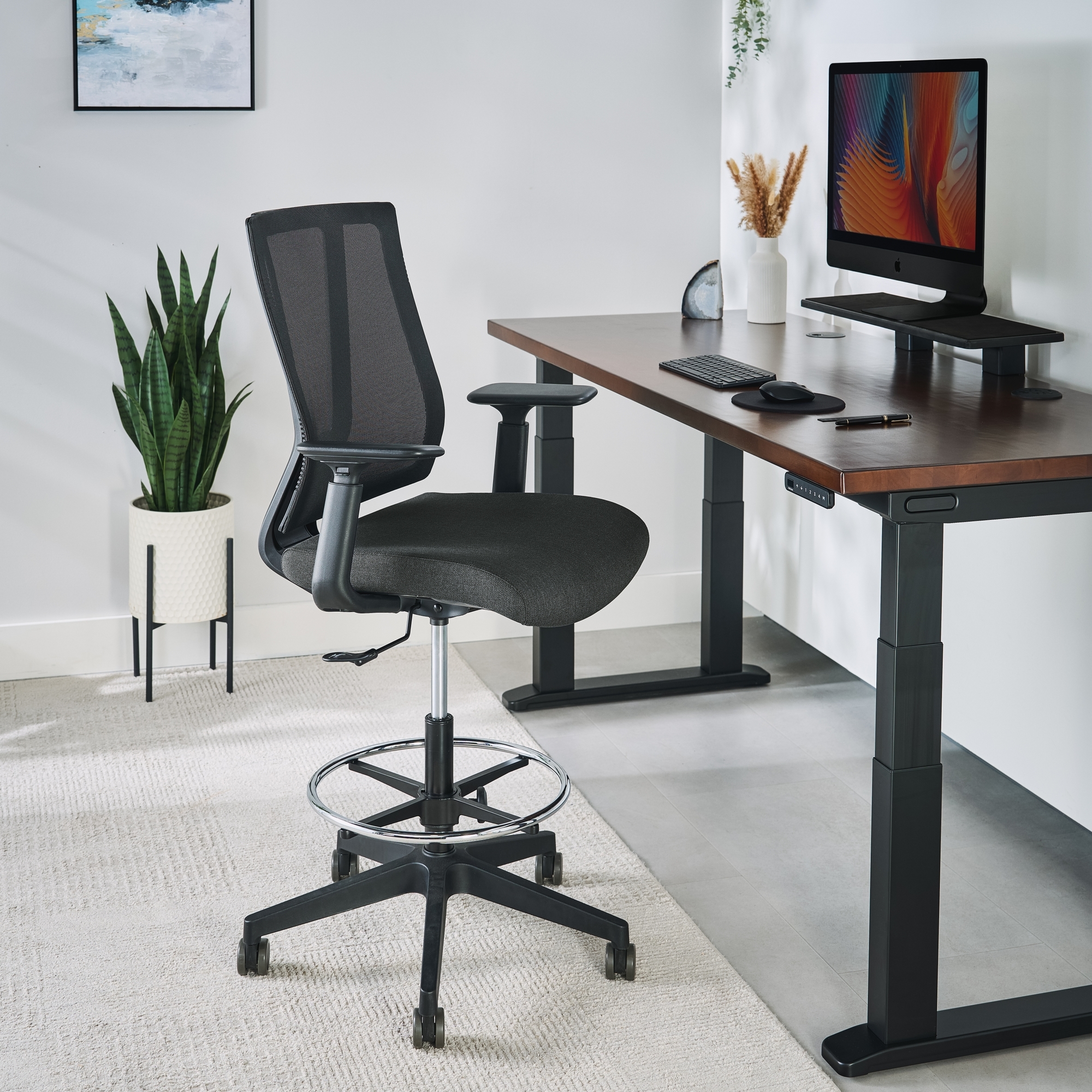 The Clarksville Ergonomic Drafting Chair in black at a 4-Leg Standing Desk by UPLIFT Desk
