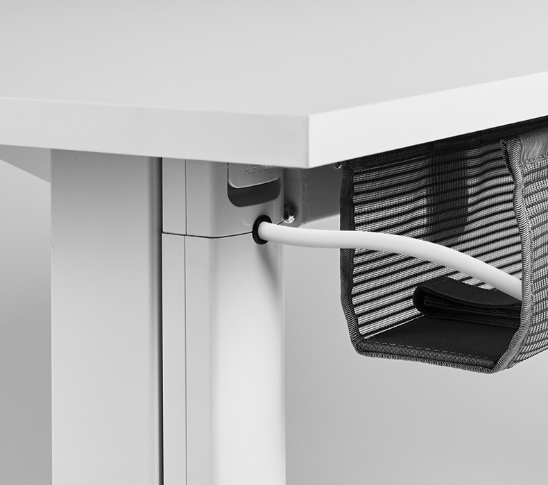 A power cable routed through the Humanscale NeatUp