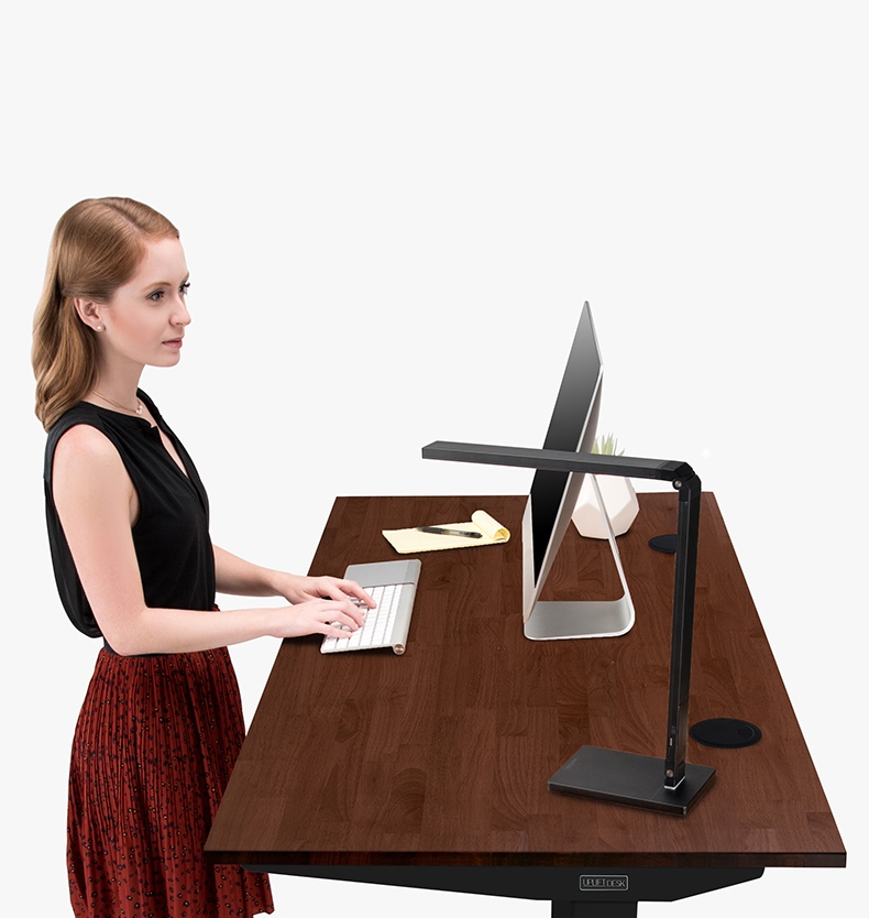 A person enjoying working at an ergonomic Rubberwood Solid Wood Standing Desk