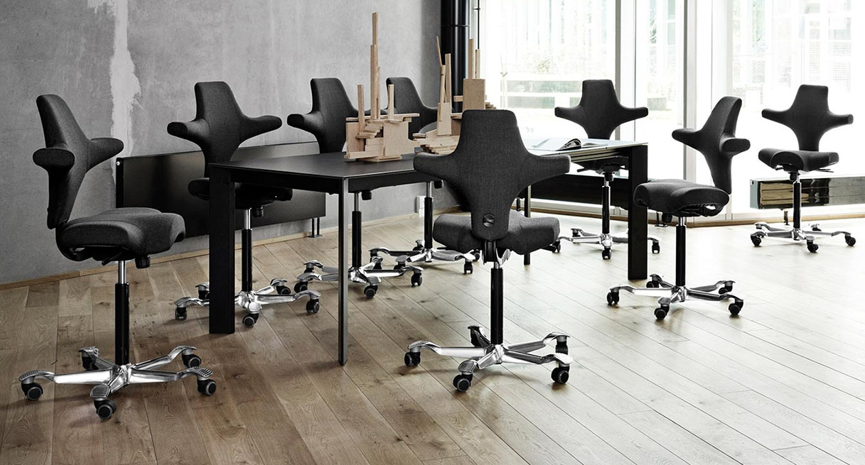 A conference room with HAG Capisco Chairs that compliment the decor