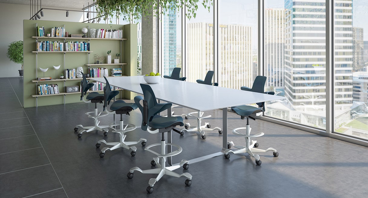 Six Capisco Puls Chairs arranged around a conference table in an open office configuration