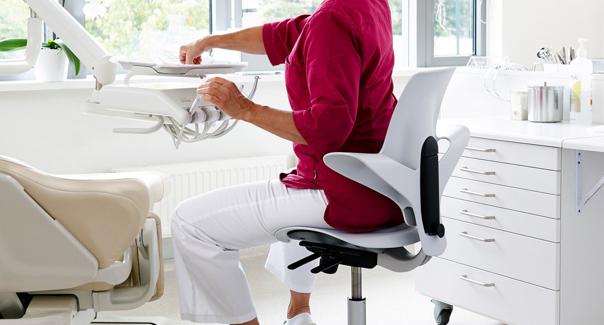 A healthcare professional sitting in a Capisco Puls Chair