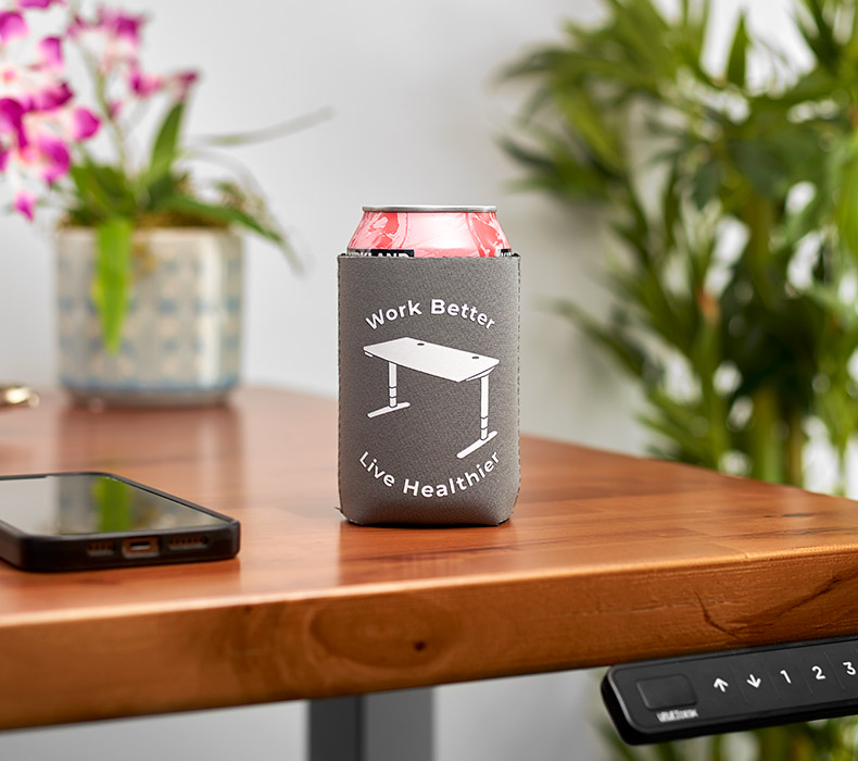 UPLIFT Koozie with can on an UPLIFT desk