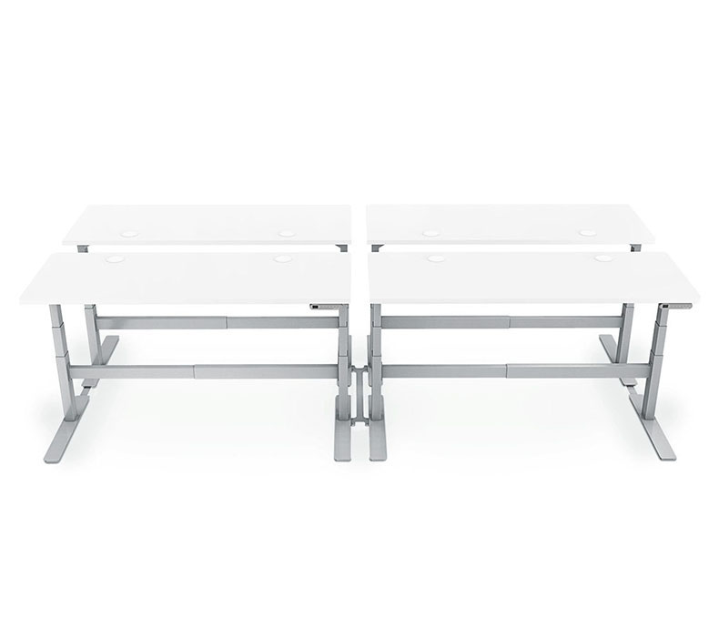 Four desks connected by a Desk Benching System V2 by UPLIFT Desk