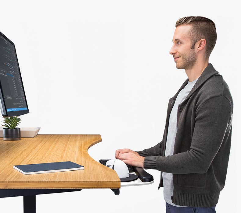 Someone using a white Big Ultra-Thin Keyboard Tray in white with a bamboo curve desktop