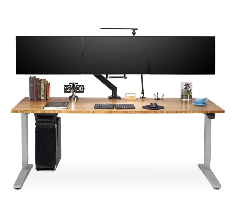 A Crestview Align Triple Monitor Arm clamp mounted to a 60 inch desktop
