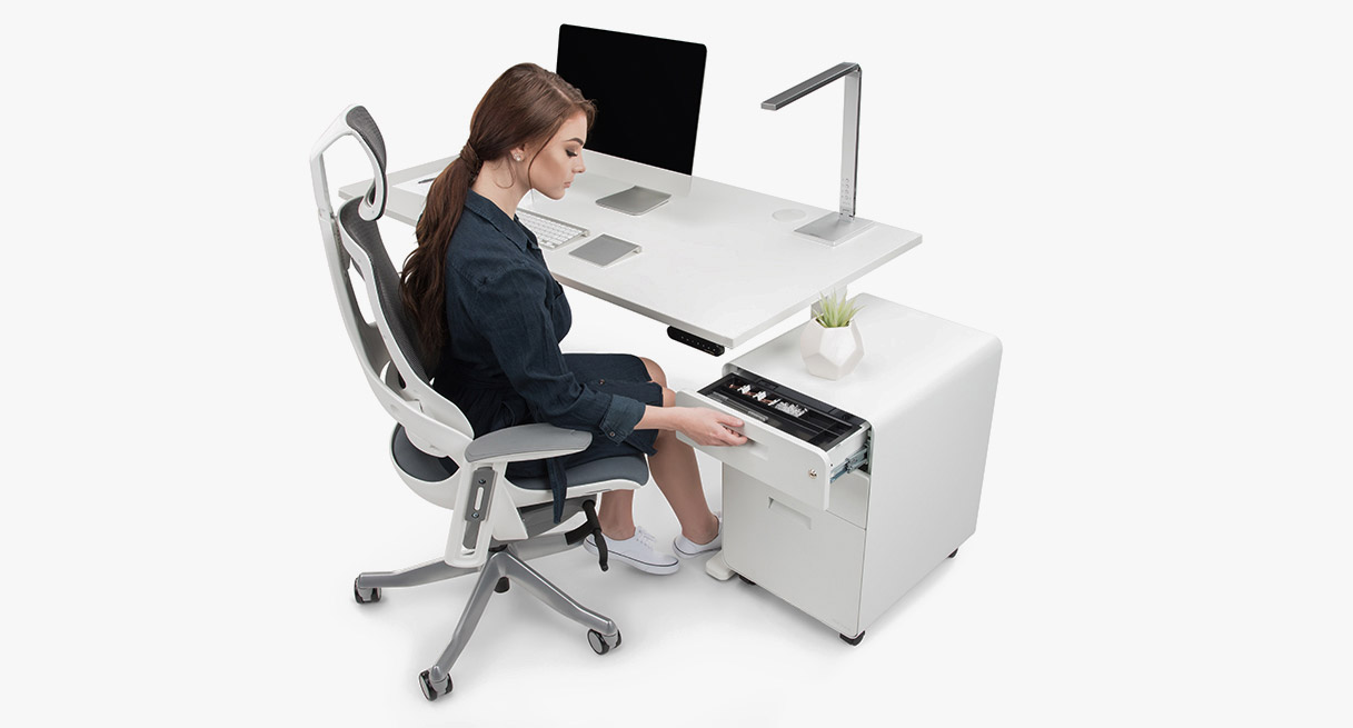 A person shutting the soft-close top drawer of an UPLIFT 3-Drawer Filing Cabinet