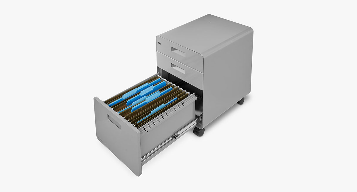 A black three drawer file cabinet on wheels with the drawers slightly open and showing  drawer glides