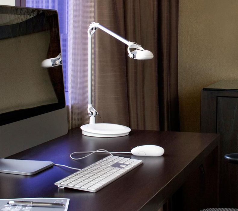 A white Humanscale Element 790 LED Light sitting on a desk