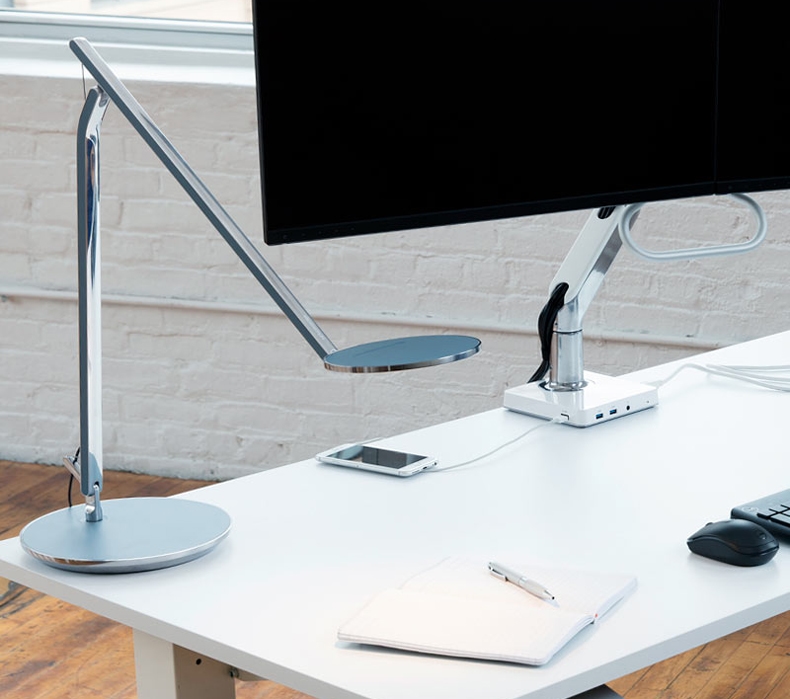 A Humanscale Infinity LED task light sitting on a desk