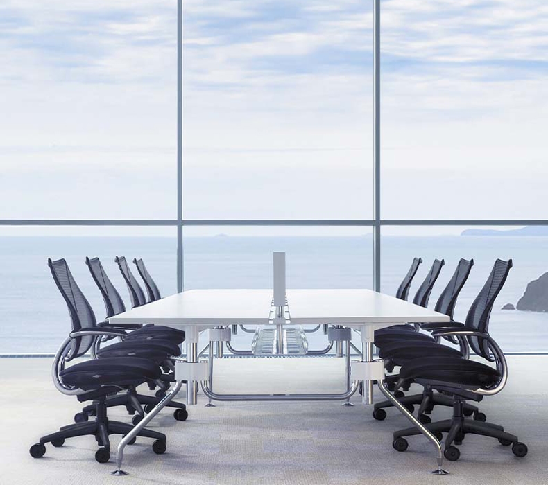 Eight Humanscale Liberty Ocean chairs with a conference table