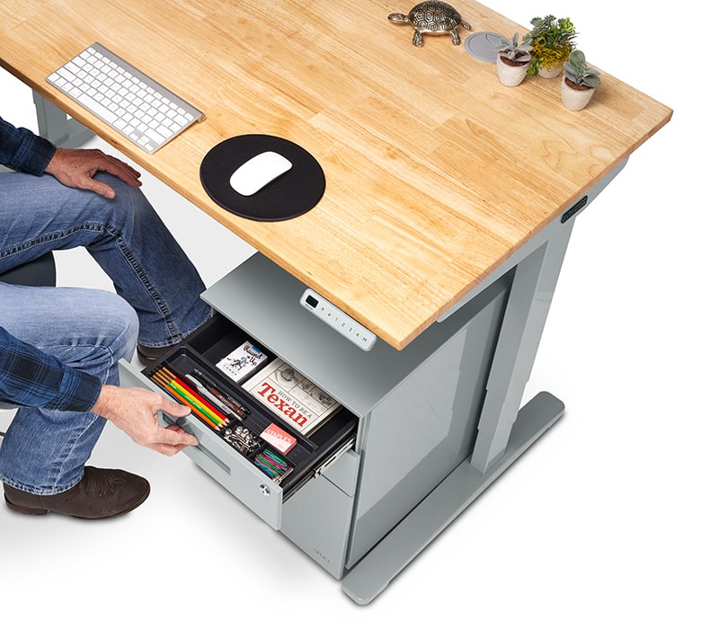 A man opens the top drawer of an UPLIFT 3-Drawer Square File Cabinet