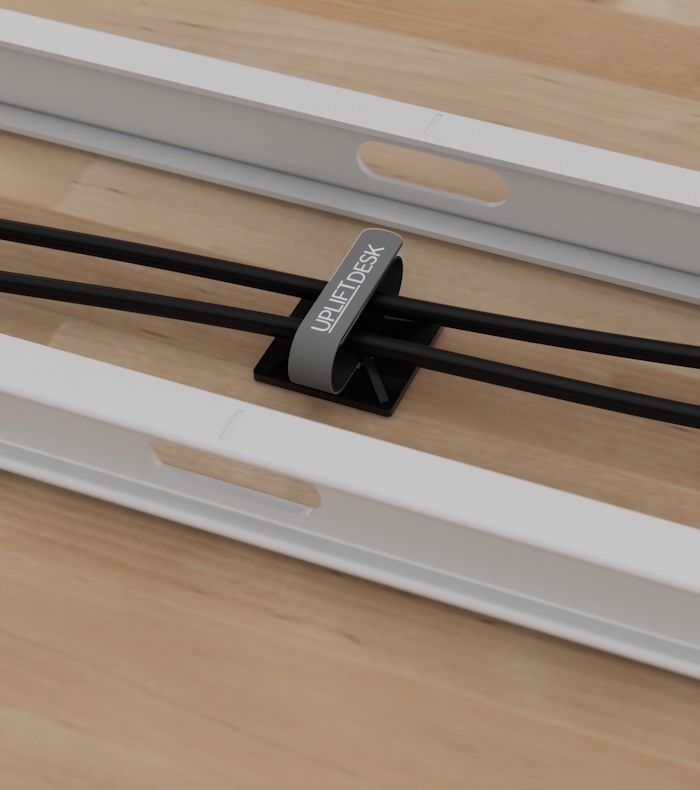 Cable wraps and an adhesive cable mount keeping two cords together and in place.