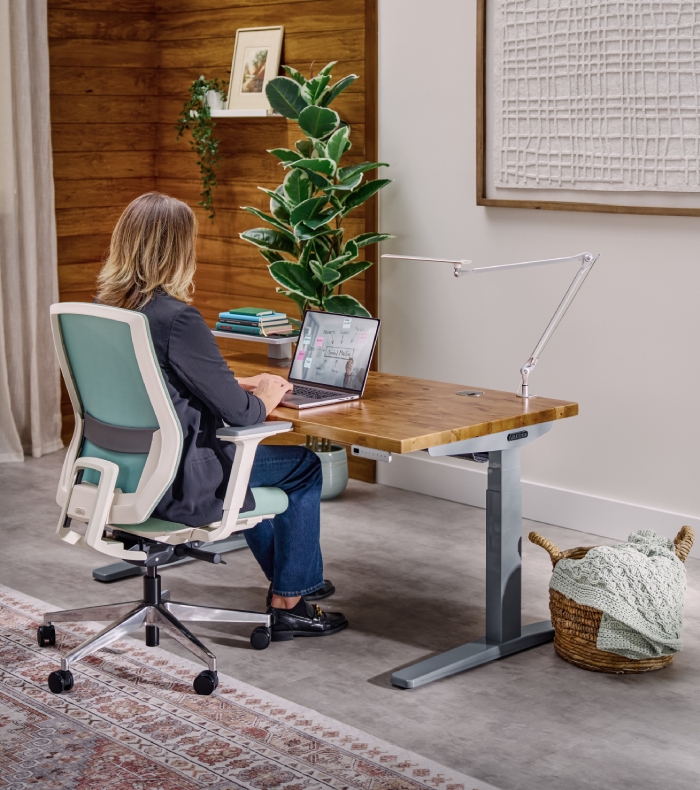 An Uplift Standing Desk with a Magnetic Cable Channel to protect and gather power cords.