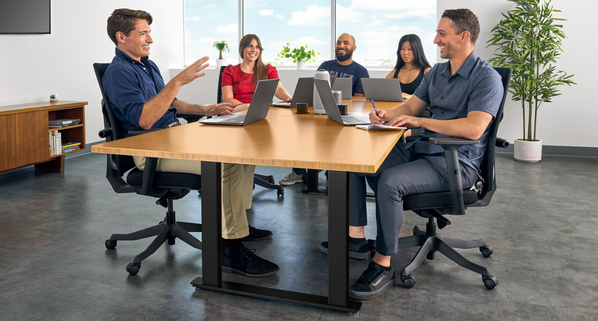 People meeting around the seated height conference table