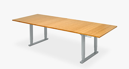 UPLIFT Height Adjustable Conference Table with Bamboo top and gray legs positioned at sitting height.